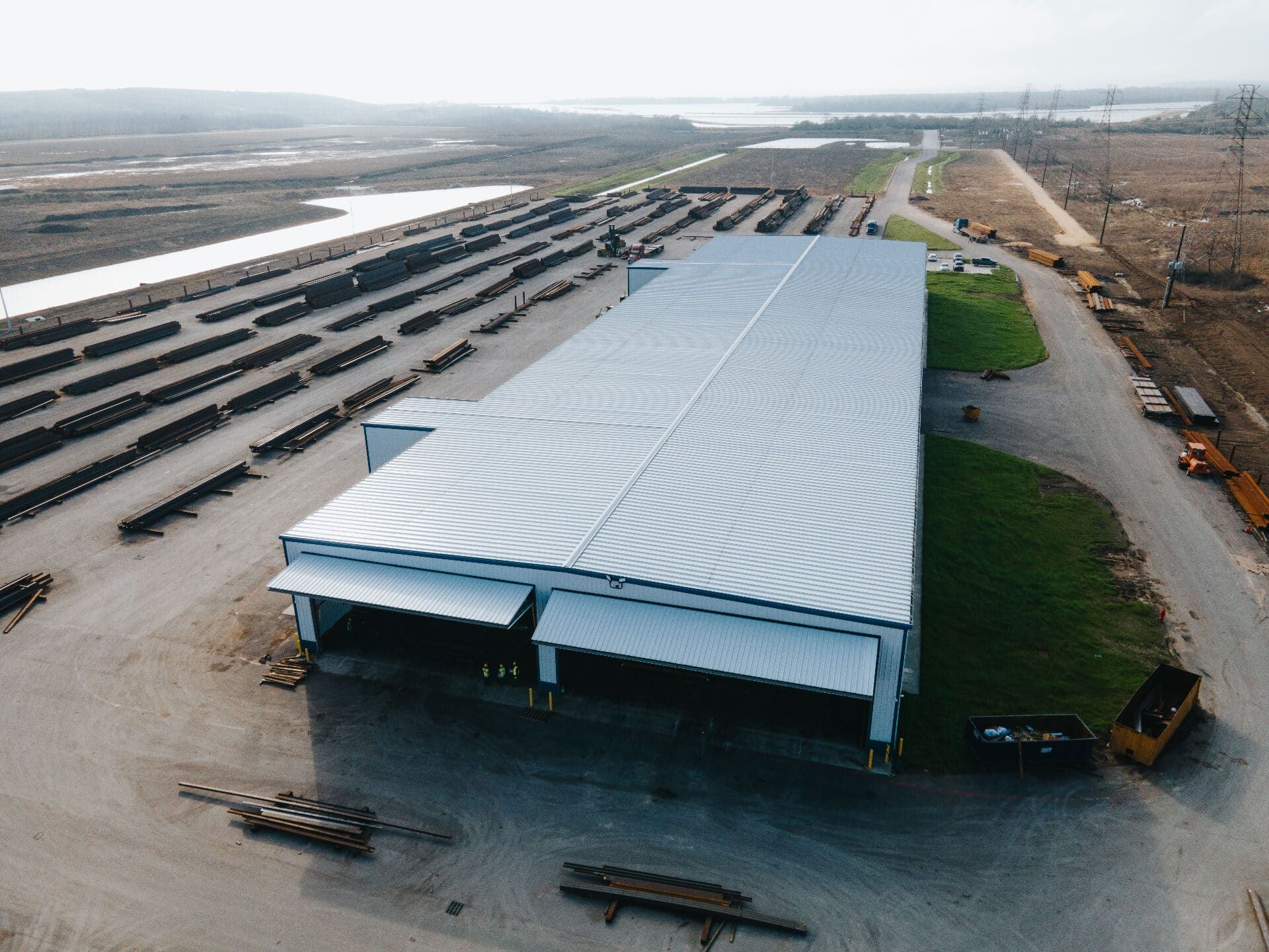 Aerial rooftop view of the Brown Strauss Houston facility with steel yard and canal in the distance