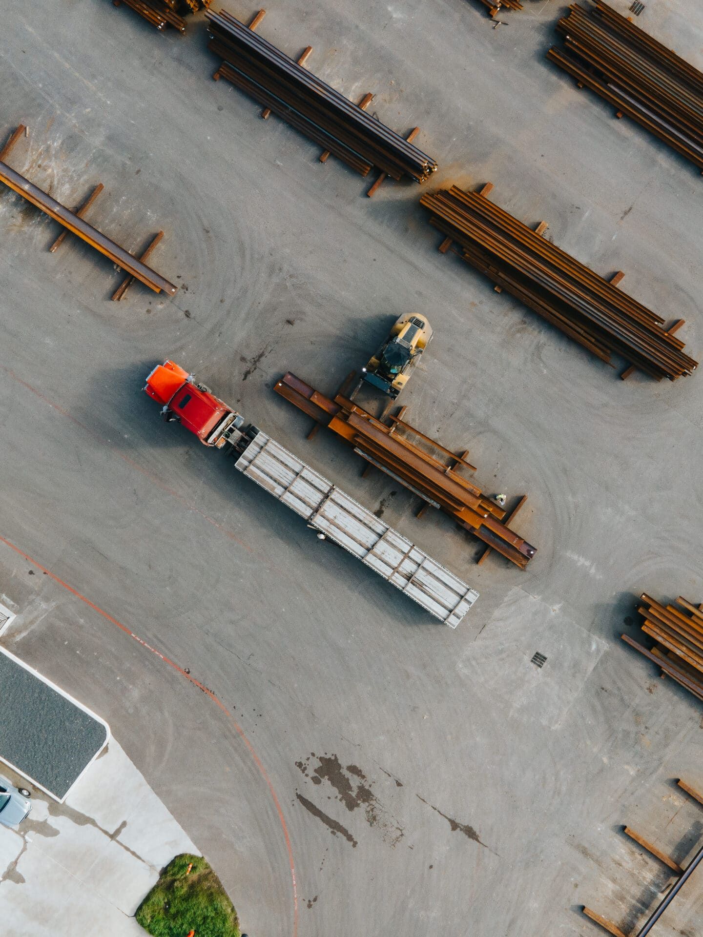Aerial view of a flatbed truck loading steel in the Brown Strauss yard