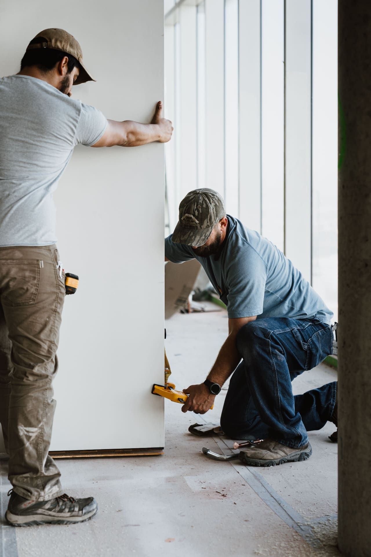 Crew installing oversized interior door