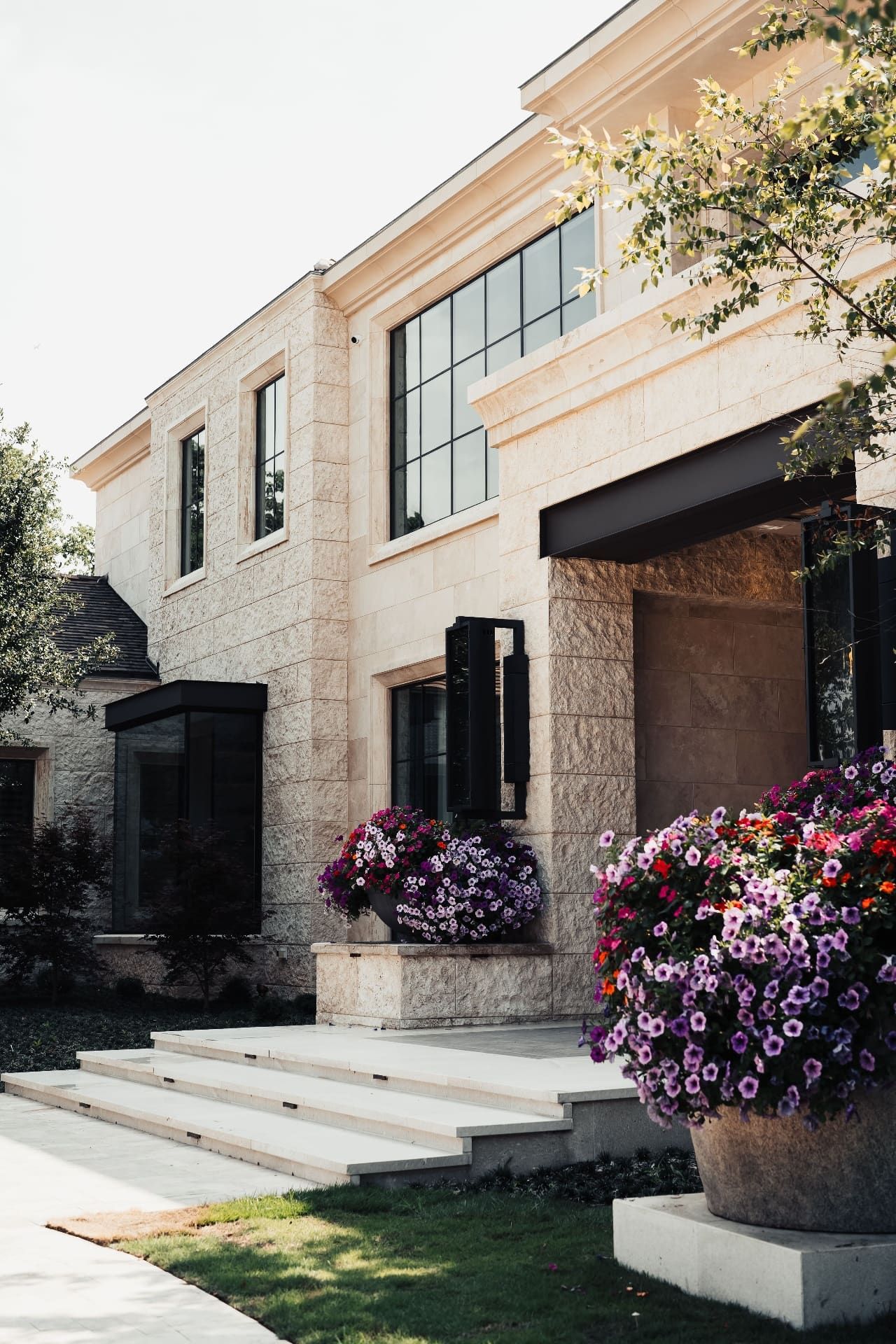 Limestone exterior with steel windows and flowers