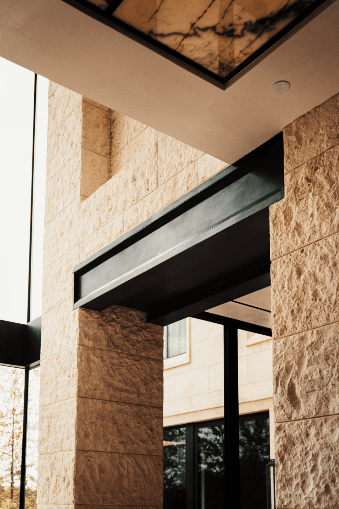 Limestone entry columns with steel beam detail